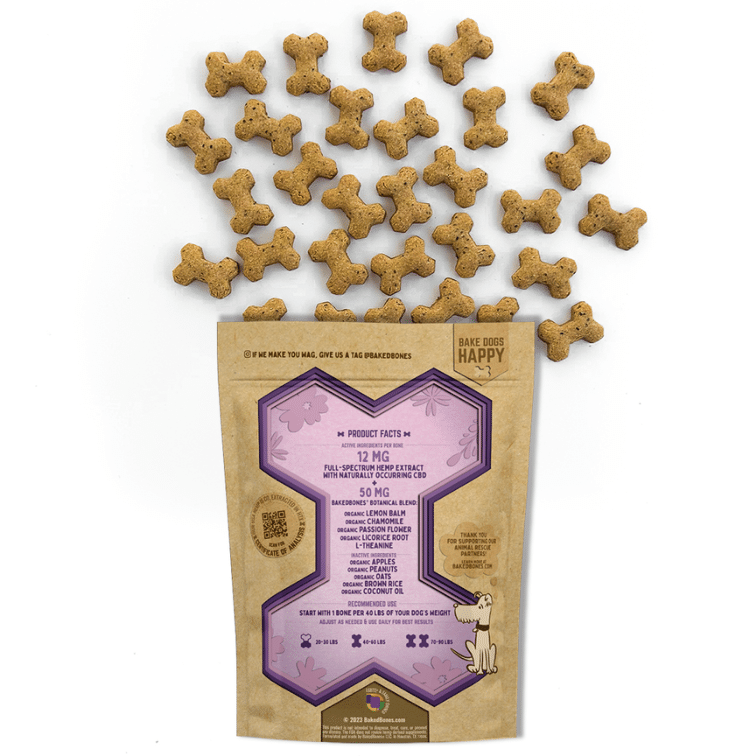 Golden-brown baked dog bones spilling out of a Kraft BakedBones bag with a purple bone and ingredients listed on the back