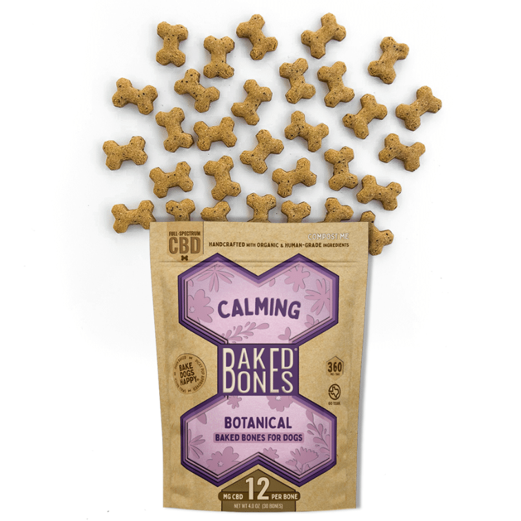 Golden-brown baked dog bones spilling out of a Kraft BakedBones bag with a purple bone and "calming" on the front