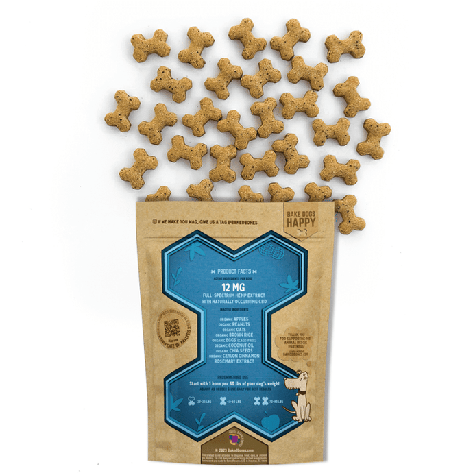 Golden brown baked dog bones dotted with black chia seeds spilling out of a Kraft BakedBones bag with a blue bone and ingredients listed on the back