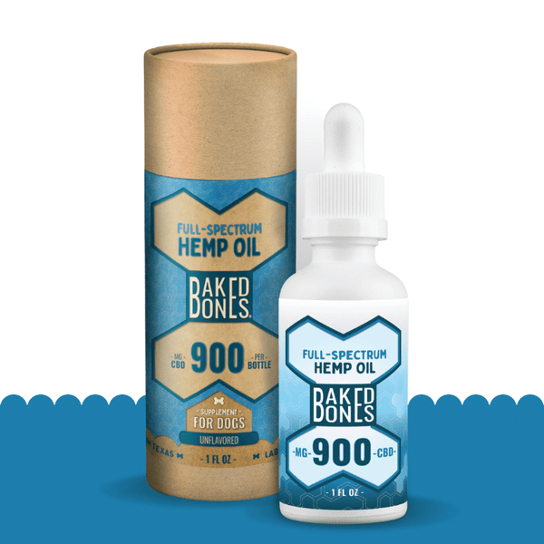 A white bottle with a blue and white label indicating that it contains 900 mg of full-spectrum CBD oil, sitting in front of its packaging, which is a kraft tube with a blue and white label indicating “full spectrum hemp oil for dogs containing 900mg of CBD.”